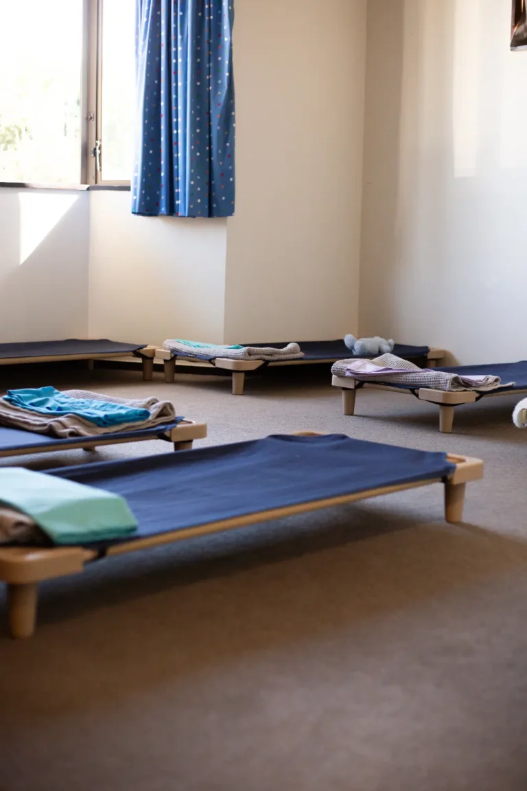 A sleep room at Lilliput Preschool with beds made up ready for moe
